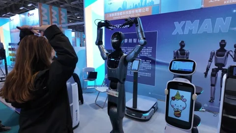 Interactive Robots at Macau Trade Fair Highlight Cutting-edge Innovations Stock Footage 320159909