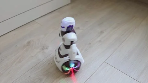 Interactive toy robot with batteries, glowing with colorful lights Stock Footage 315554714