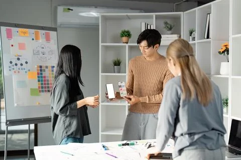 Interactive UX UI design presentation with mobile app mockup and team Stock Photos