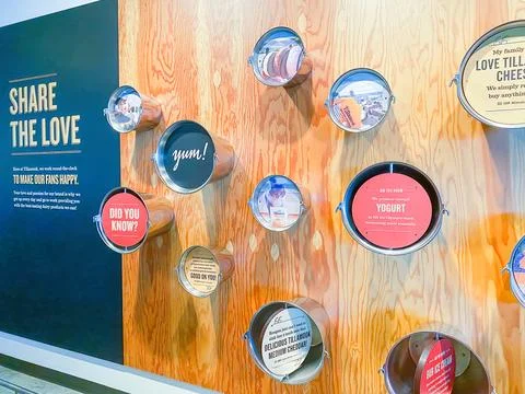 Interactive wall display featuring metal buckets with facts and quotes at a.. Photos