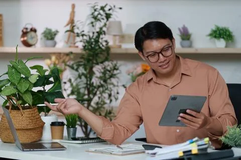 Interactive Workspace. Man using tablet for communication in modern office. Stock Photos
