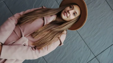Interception portrait of Charming long hair young woman in a coat and round hat Stock Footage 165737708
