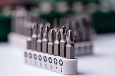 Interchangeable screwdriver bit set, isolated on white, selective focus,  dof Stock Photos