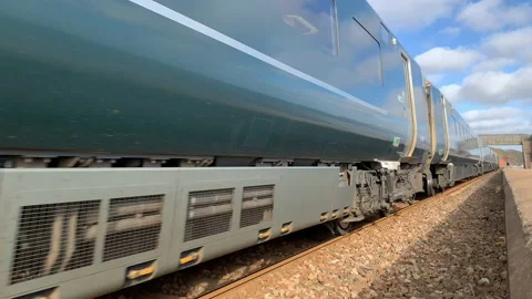 Intercity fast train close up moving along coast UK 4K Stock Footage 232867349
