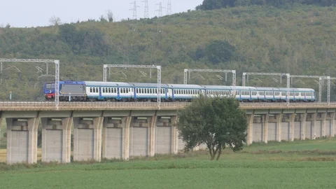 Intercity train passes over the elevated Stock Footage 100557306