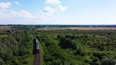 Intercity train rides into the distance, drone view of the train in motion Stock Footage 201064207