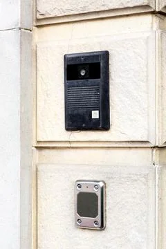 Intercom black on the light stone wall of the facade of  building closeup. Stock Photos