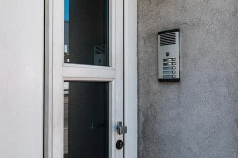Intercom on a gray wall next to the front door on the street Stock Photos