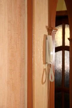 The intercom handset hangs in profile in the reflection of a mirror Stock Photos