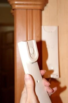 Intercom handset in a woman's hand - vertical photo Stock Photos