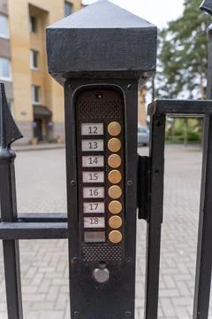 Intercom panel with a video camera on the brick fence of private house Stock Photos