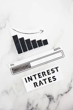Interest rates going down, text with graph showing stats decreasing and pro.. Stock Photos