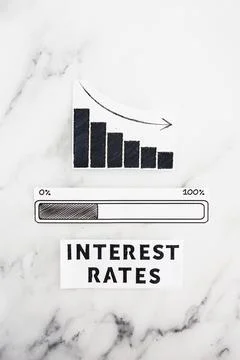 Interest rates going down, text with graph showing stats decreasing and pro.. Stock Photos