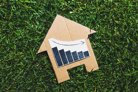 Interest rates going down, text with graph showing stats decreasing and progr Stock Photos