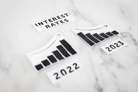 Interest rates text with 2022 chart showing stats increasing and 2023 graph.. 写真素材