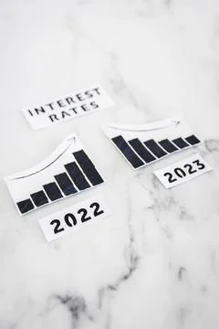 Interest rates text with 2022 chart showing stats increasing and 2023 graph.. 写真素材