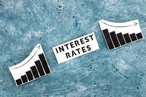 Interest rates text in between graphs with stats going up then going down, ec Stock Photos