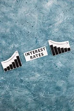 Interest rates text in between graphs with stats going up then going down, ec Stock Photos