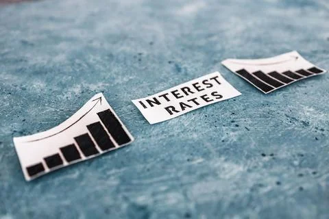 Interest rates text in between graphs with stats going up then going down, ec Stock Photos