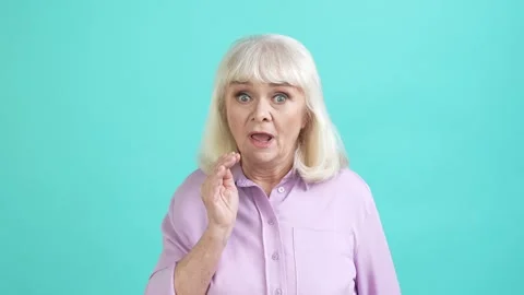 Interested aged lady share private novelty isolated aquamarine color background Stock Footage 196147055