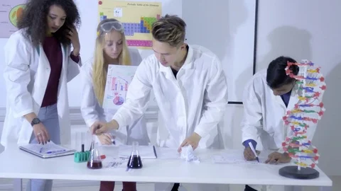 Interested college students writing down the results of an experiment 스톡 동영상 74623951