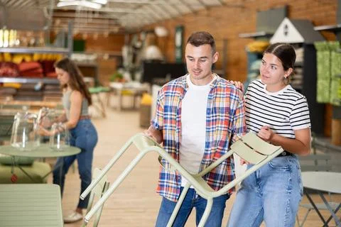 Interested couple looking for functional chairs in furniture store Foto stock
