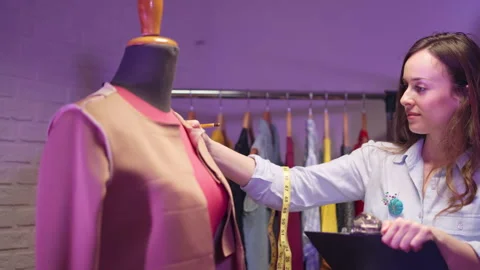 Interested female couturier working on jacket sketch in atelier studio Video stock 306935688