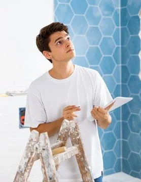 Interested guy making notes while planning house overhaul Stock Photos
