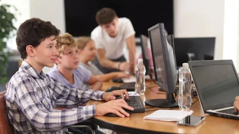 Interested preteen boys working on computer together during IT courses for Video stock 274462001