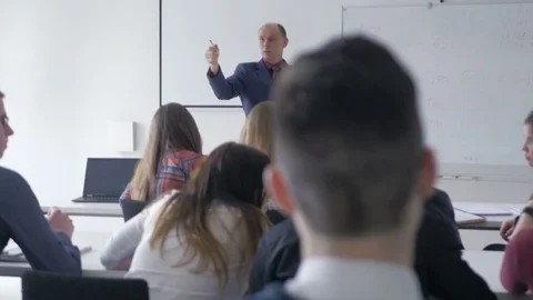 Interested students listening to a lecture in a classroom Stock Footage 69931536