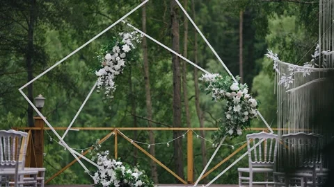 An interesting angular wedding arch decorated with flowers Stock Footage 220155113