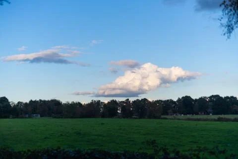 Interesting cloud formations in  the sky while the blue of the sky is still v Stock Photos