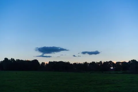 Interesting cloud formations in  the sky while the blue of the sky is still v Stock Photos