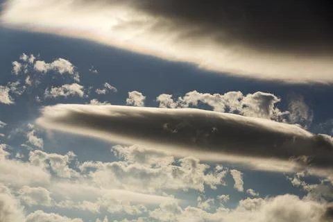 Interesting cloud patterns over the Lake District, UK, with rainbow patterns. Stock Photos
