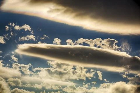 Interesting cloud patterns over the Lake District, UK, with rainbow patterns. Stock Photos