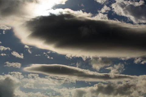 Interesting cloud patterns over the Lake District, UK, with rainbow patterns. Stock Photos