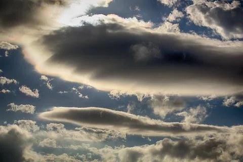 Interesting cloud patterns over the Lake District, UK, with rainbow patterns. Stock Photos
