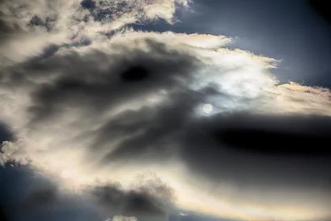 Interesting cloud patterns over the Lake District, UK, with rainbow patterns. Stock Photos