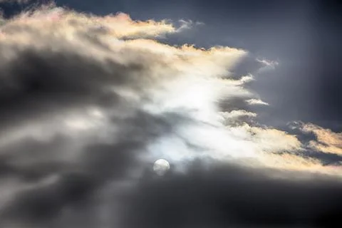 Interesting cloud patterns over the Lake District, UK, with rainbow patterns. Stock Photos