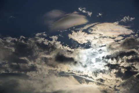 Interesting cloud patterns over the Lake District, UK, with rainbow patterns. Stock Photos