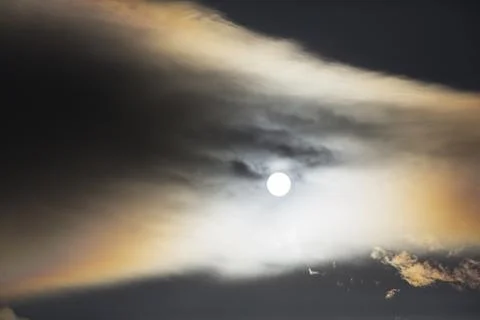 Interesting cloud patterns over the Lake District, UK, with rainbow patterns. Stock Photos
