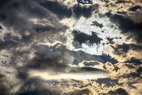 Interesting cloud patterns over the Lake District, UK, with rainbow patterns. Stock Photos