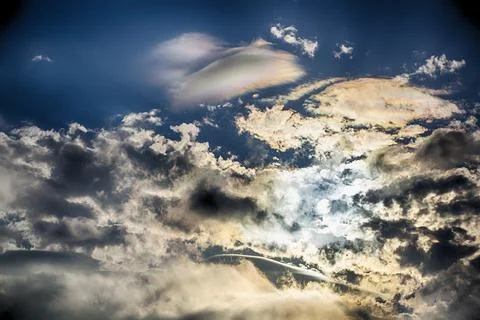 Interesting cloud patterns over the Lake District, UK, with rainbow patterns. Stock Photos