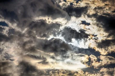 Interesting cloud patterns over the Lake District, UK, with rainbow patterns. Stock Photos