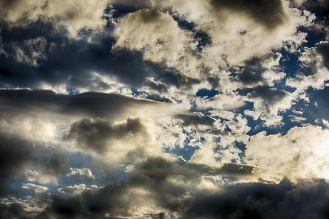 Interesting cloud patterns over the Lake District, UK, with rainbow patterns. Stock Photos