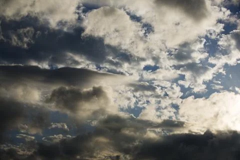 Interesting cloud patterns over the Lake District, UK, with rainbow patterns. Stock Photos