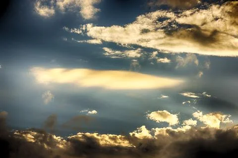 Interesting cloud patterns over the Lake District, UK, with rainbow patterns. Stock Photos