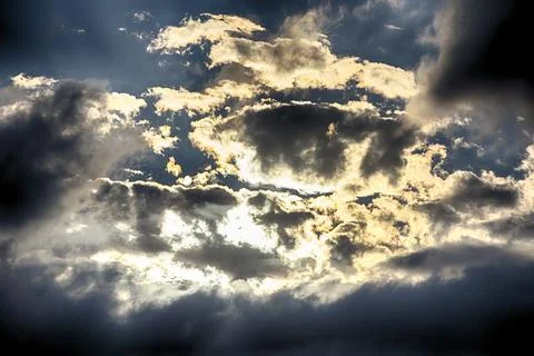 Interesting cloud patterns over the Lake District, UK, with rainbow patterns. Stock Photos