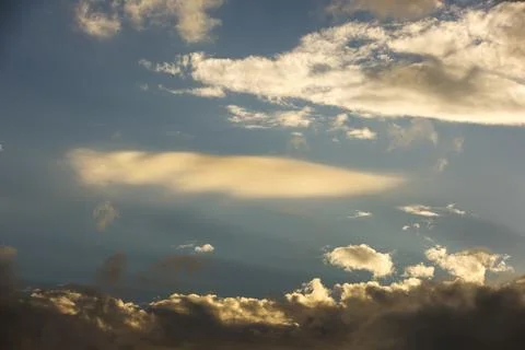 Interesting cloud patterns over the Lake District, UK, with rainbow patterns. Stock Photos