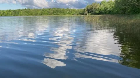 Interesting cloud shapes and reflection in beautiful summer lake setting Stock Footage 185745994